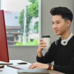 professional creative man drinking coffee and work 45dh35y